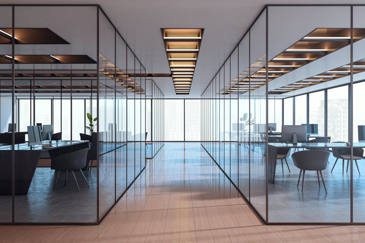 Contemporary empty office interior with glass partitions and city view