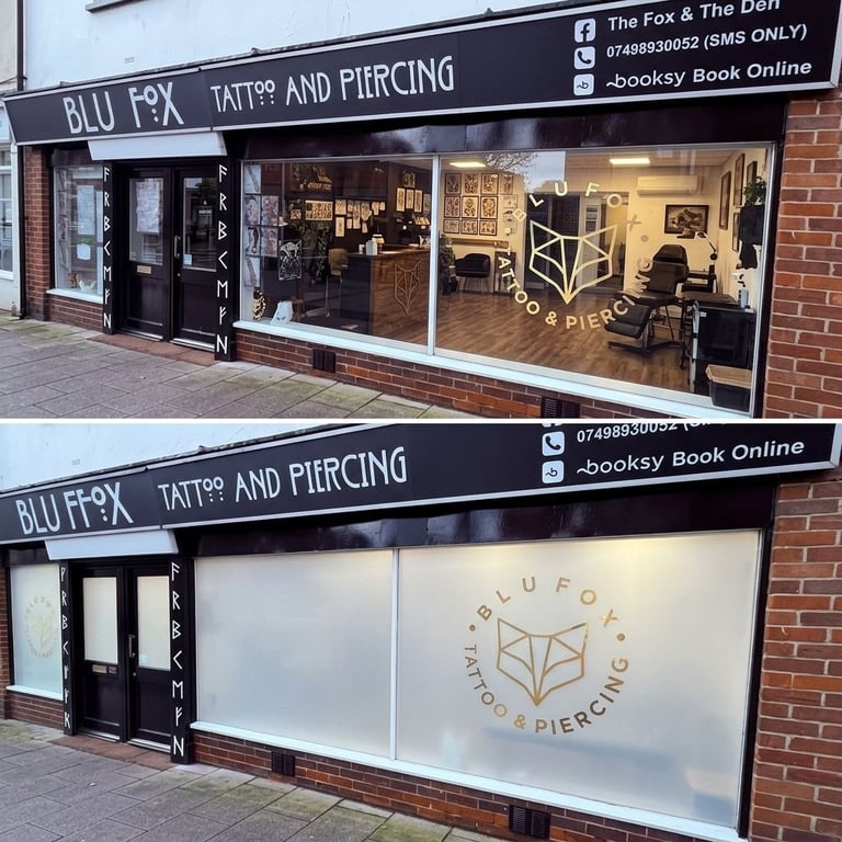Blu Fox tattoo and piercing studio storefront with brick exterior, black signage, and display windows showing interior workspace